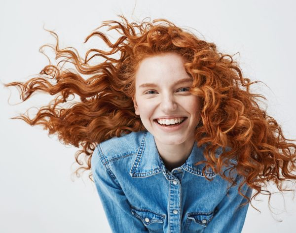 Portrait,Of,Beautiful,Cheerful,Redhead,Girl,With,Flying,Curly,Hair